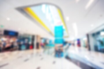 An abstract, blurred view of a modern shopping mall in Shenzhen, China. The bokeh effect creates a sense of movement and depth.