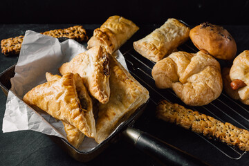 Freshly Baked Pastries and Croissants on a Dark Surface