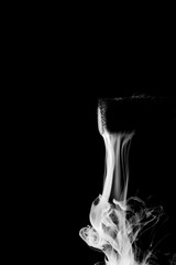 Smoke Flowing Silently from a Mystical Object Against Black Background