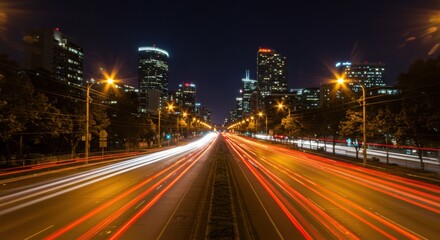 Fototapeta premium Blurred motion of city lights at night, conveying speed or energy, long exposure