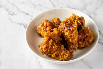 Crispy Fried Chicken Wings with Sweet Glaze on Marble Background