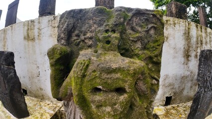  Historic gravestone with intricate carvings and engravings displayed in the open area of the Chapel of St. Catherine, Old Goa