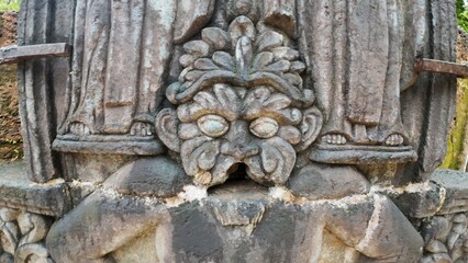  Historic gravestone with intricate carvings and engravings displayed in the open area of the Chapel of St. Catherine, Old Goa