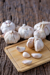 Fresh Garlic Bulbs and Cloves on Rustic Wooden Table Surface