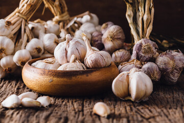 Fresh Garlic Bulbs and Cloves in Wooden Bowl on Rustic Table