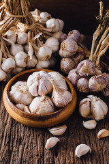 Fresh Garlic Bulbs and Cloves on Rustic Wooden Surface