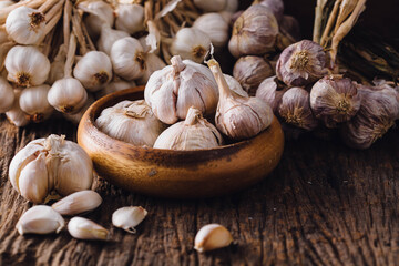 Fresh Garlic Bulbs and Cloves in Wooden Bowl on Rustic Table
