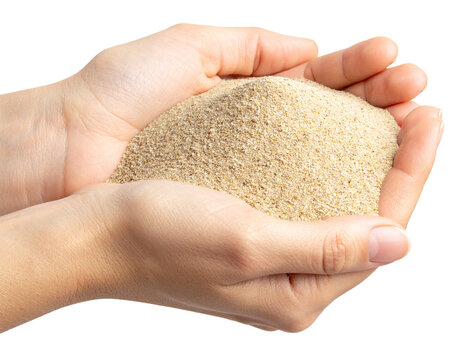closeup of handful of sand beach isolated on white background