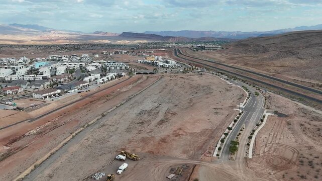 Aerial view of suburban edge in St. George with desert highway and scattered housing plots