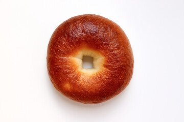 A delicious plain bagel. A well-baked, brown loaf. 