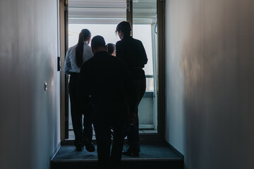 Business people walking towards bright outdoor terrace