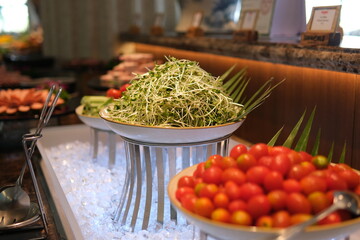 Assorted fresh salads displayed on a buffet in individual containers at a catered event or...
