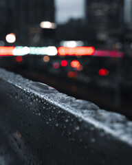 wet railing and cars on the street