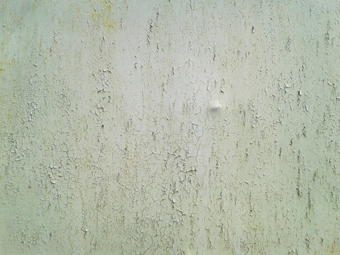 Old green light painted metal with rust spots and cracks. Grunge texture.