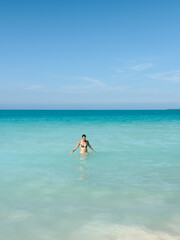 Obraz premium Young Woman Standing in the Clear Sea