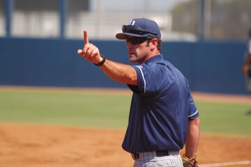 Coach Signal During Baseball Game with Focused Expression