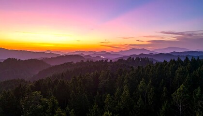 Obraz premium Panoramic view of a mountain range at sunrise or sunset. Colorful sky blends into the hills