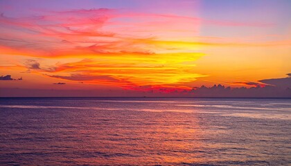 Obraz premium Vibrant tropical sunset painting the sky with fiery orange, pink, and purple hues over the calm ocean. Stunning natural beauty, perfect for travel or backgrounds.