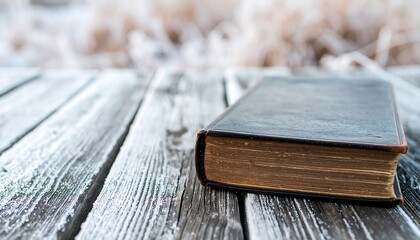 Old book on weathered wood in winter
