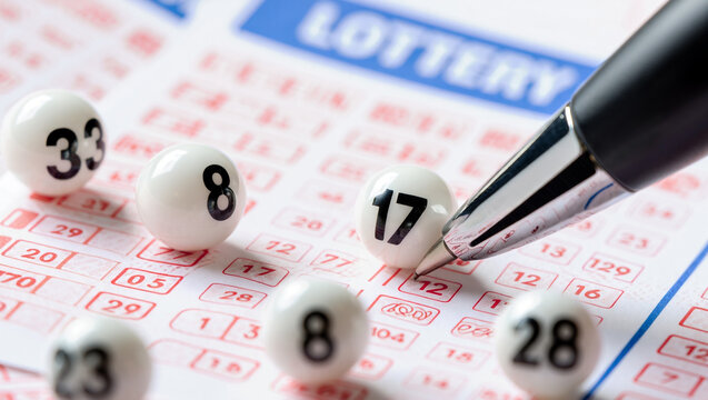 Closeup of Lottery Ticket Powerball with Numbers and Pen.