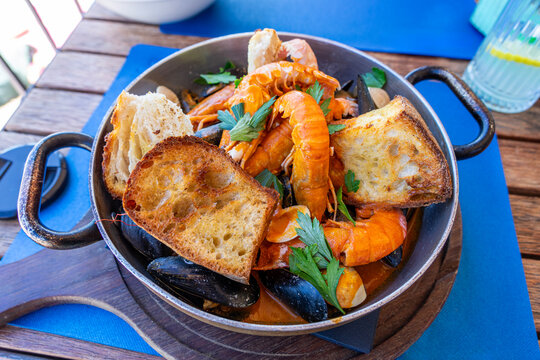 buzara traditional seafood dish in Croatia with shrimp mussels and red sauce