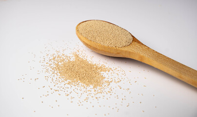 Dry yeast on wooden spoon — baking ingredient