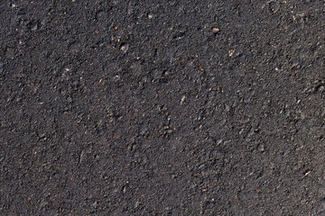 details of the black new asphalt on the highway, part of the newly built asphalt highway made of bitumen with crushed stone and sand