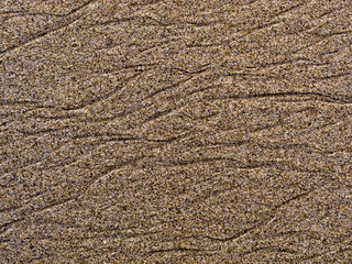Close-up of sand with wave-like patterns