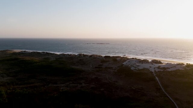 Aerial view of Ofir beach in northern Portugal with dunes and ocean at sunset glow