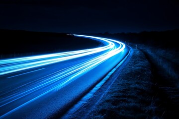Obraz premium Glowing Blue Light Trails on Highway at Night with Dark Background