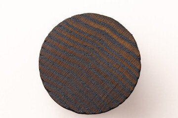 Round dark wood lid on a white background, clear wood texture