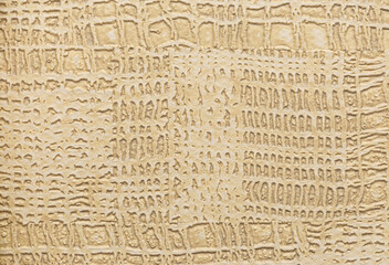 Wallpaper with reptile skin texture in beige shades, macro shot