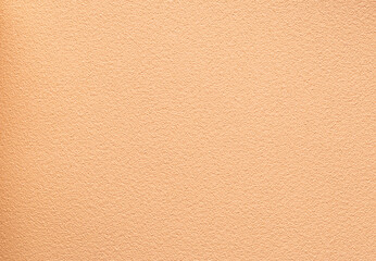 Fototapeta premium Warm peach stucco wall texture background for interior branding and product mockup