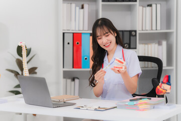 Smiling Medical Professional Explaining Dental Model