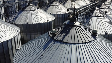 An Aerial View of Large Grain Storage Silos Brightly Bathed in Warm, Radiant Sunlight