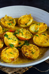 Traditional Bengali egg malaicurry or dim malaikari, boiled eggs cooked in rich coconut milk gravy with spices, authentic Indian curry from Bengal cuisine served with steamed rice as festive meal
