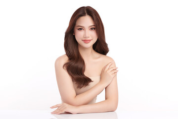 Naklejka premium A beautiful young Asian woman with clean, fresh skin against a white background. Skincare, facial treatment, cosmetology, beauty, and spa. An elegant portrait of an Asian woman.