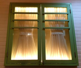 simple house windows lit by dim lights