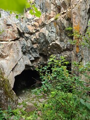 Mysterious Cave Entrance Amidst Rocky Terrain A Geological Wonder and Natural Hideaway