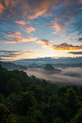 A breathtaking aerial view of a mountain village bathed in early sunlight, with misty valleys and dramatic peaks in the background. The scene captures the serene beauty of nature