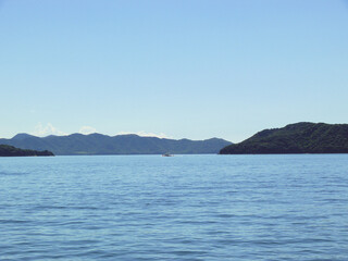 Panoramic view of the Inland Sea of Japan with a ship sailing between islands.