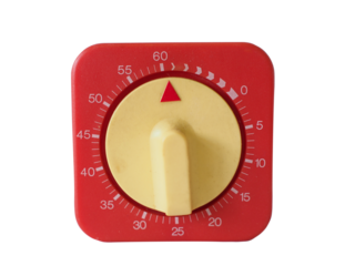 Close-up of a red mechanical timer with yellow dial, used for cooking or laboratory timing.