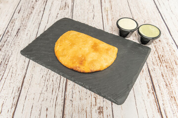 Perfectly browned Venezuelan empanadas with their characteristic deep yellow color, filled with shredded beef and melted white cheese