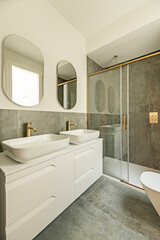 Elegant contemporary bathroom with an oval porcelain sink, minimalist chrome faucets, and a large clear glass shower enclosure