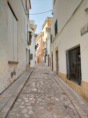 Fototapeta premium n Sant Joan Street, Sitges, Barcelona. Beautiful street in the town of Sitges tourism.