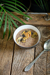 flaxseed porridge with apple. Side view, wooden background