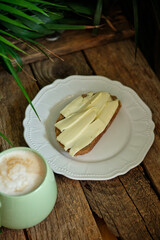 toast with butter and cheese. breakfast, side view, wooden background