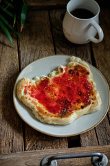 Flatbread with jam. Side view, wooden background