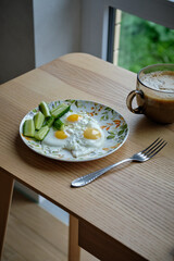 Breakfast. Fried eggs and cucumbers