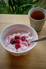 Cottage cheese with sour cream and cherry confit. side view	